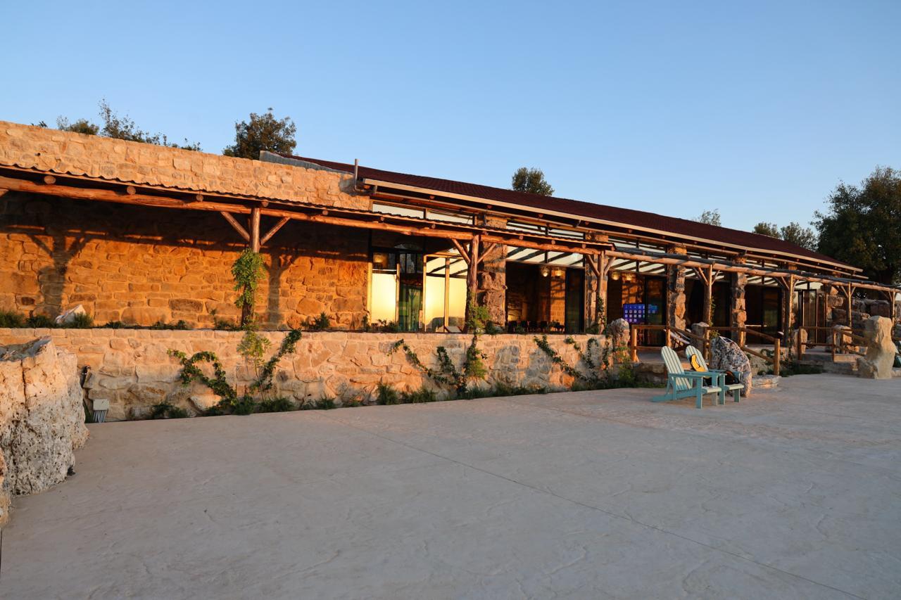 The stone exterior and terrace of 1000M Venue at golden hour