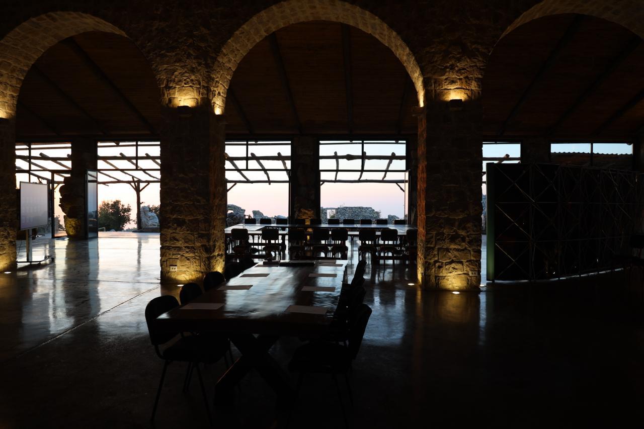 The hall at dusk with arches lit from below
