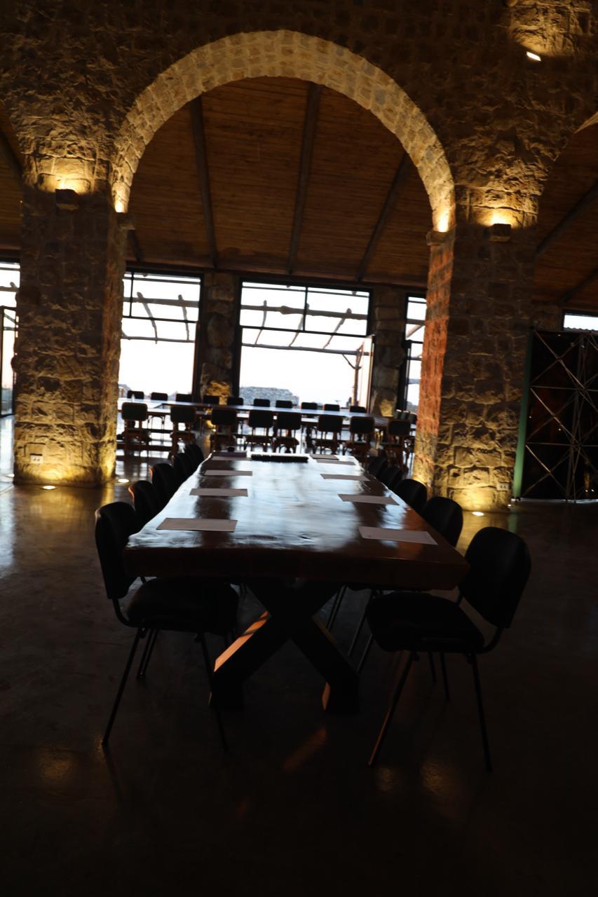 Long table beneath the grand arch at dusk