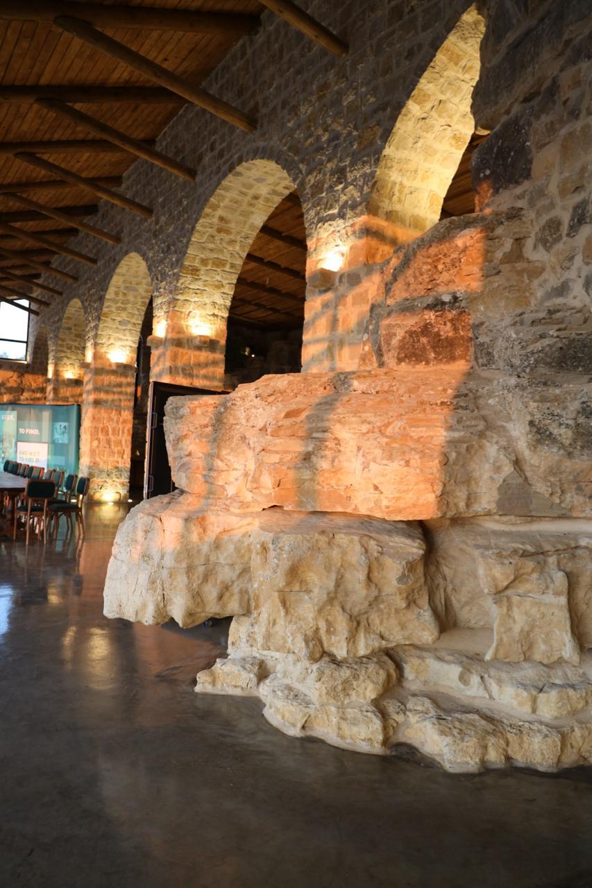 Arcade of illuminated stone arches in the Grand Hall