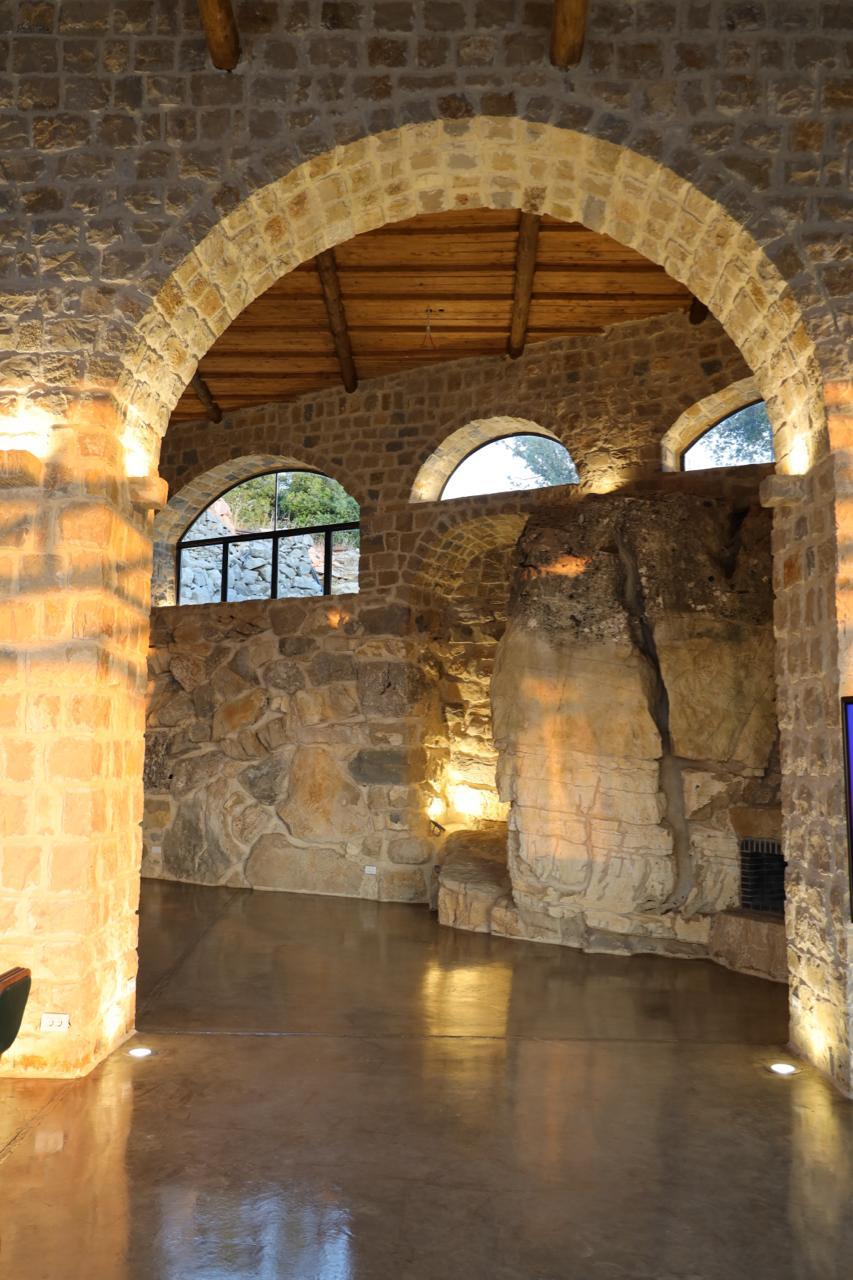 Stone arch framing a natural rock formation inside 1000M Venue