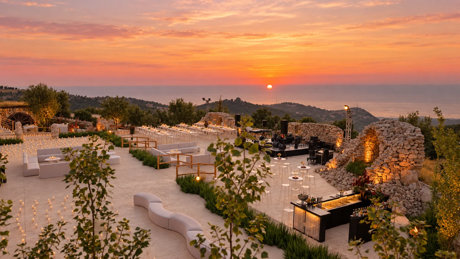 The terrace and stone ruins at 1000M beneath an orange sunset in Hjoula